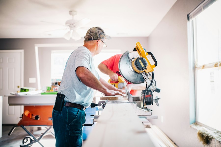 A contractor cutting wood with a miter saw