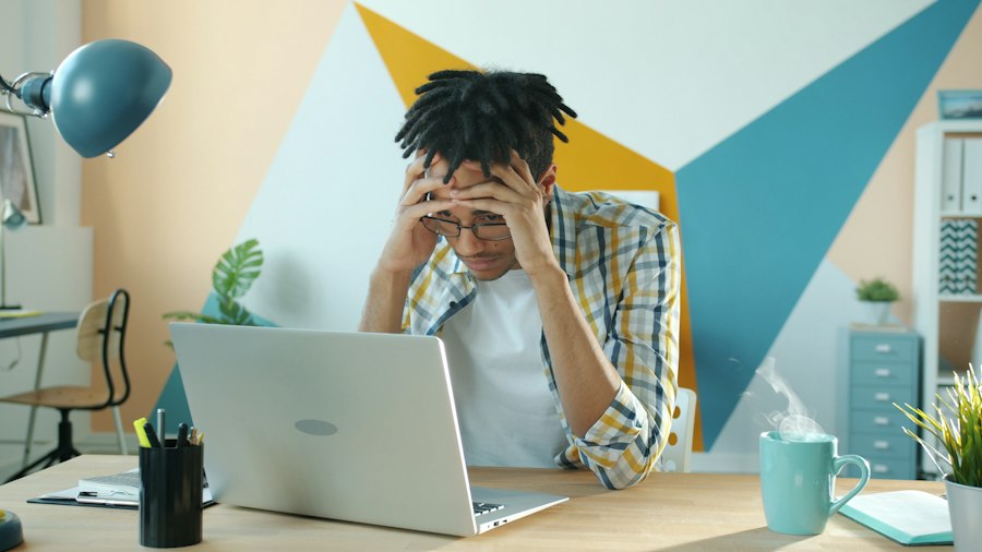A business owner stressed at his laptop